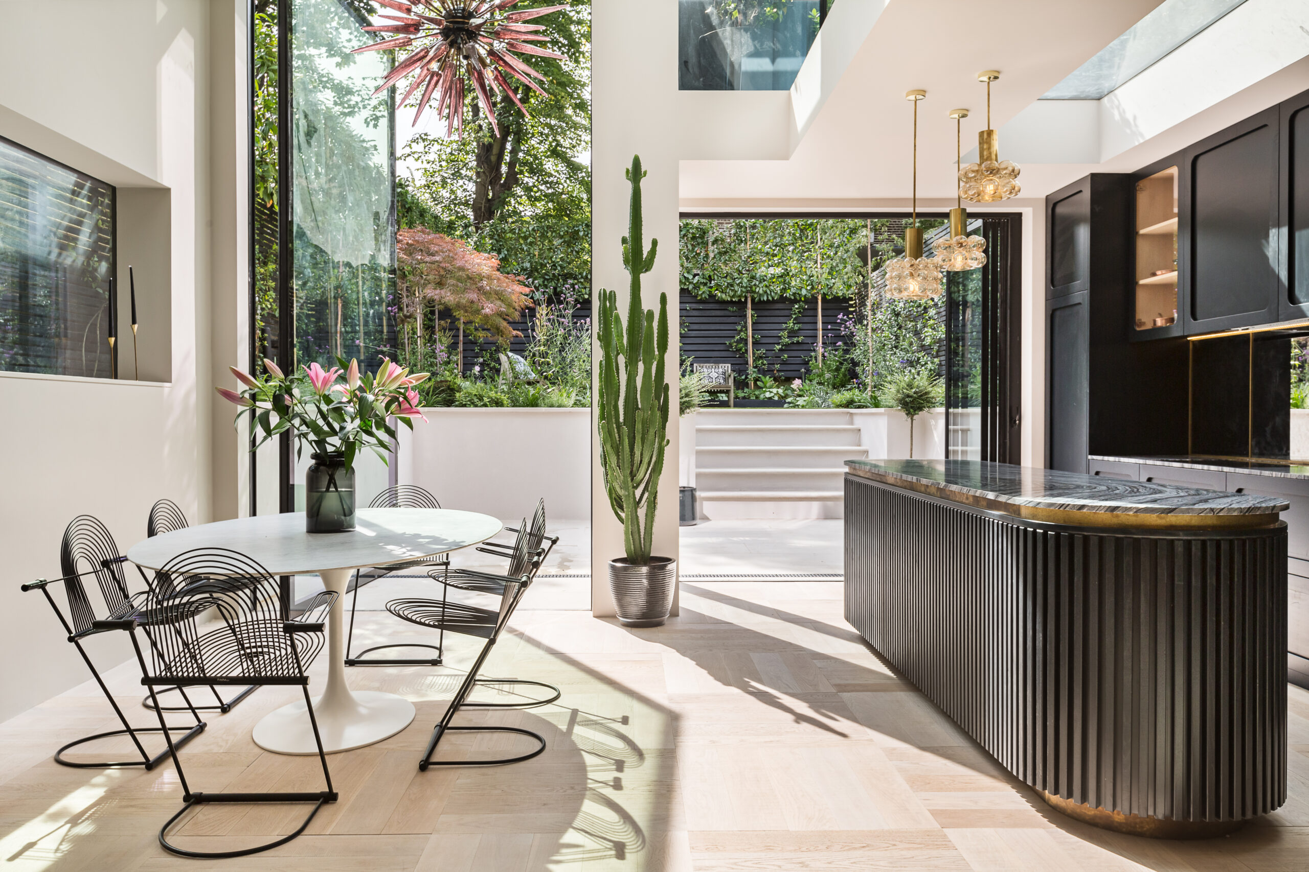 For Rent, Oxford Gardens North Kensington W10, open-plan kitchen and dining room with full-height glass, house plants and art deco furniture